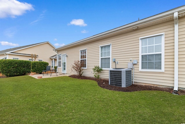 back of property featuring cooling unit, a patio, and a lawn