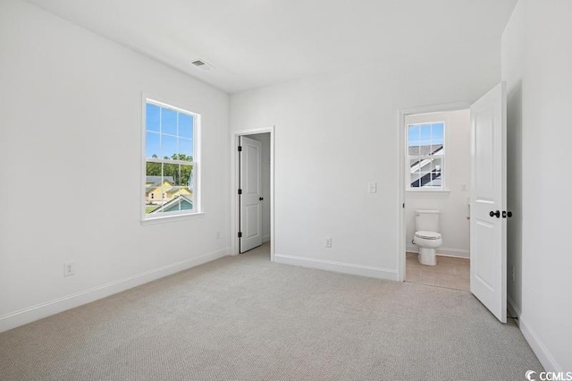 1800 Tryon Dr, Myrtle Beach, SC 29588 - unfurnished bedroom with light colored carpet, baseboards, and ensuite bath