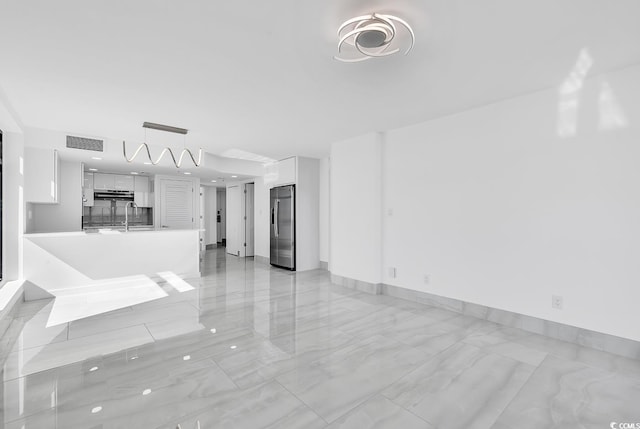 unfurnished living room featuring sink