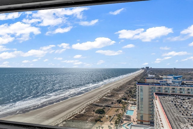 birds eye view of property featuring a water view and a beach view