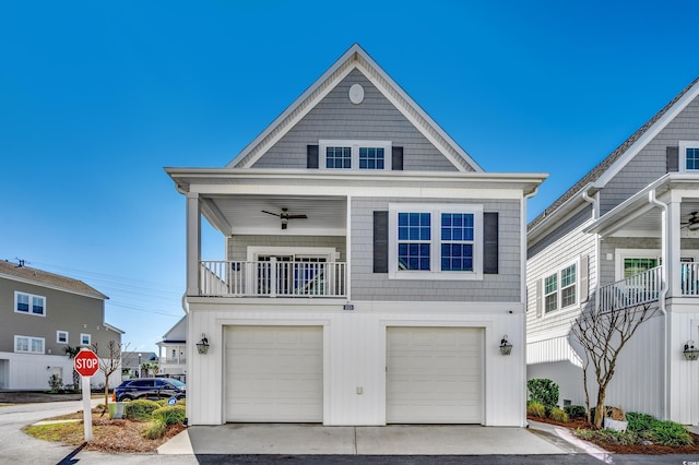 view of front of home featuring an attached garage, driveway, and ceiling fan