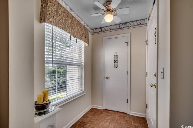 8545 Hopkins Cir Unit G, Myrtle Beach, SC 29575 - entryway featuring a textured ceiling, ceiling fan, and baseboards