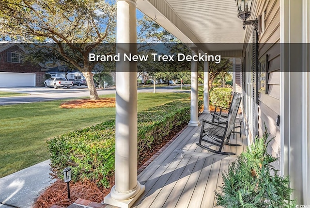 wooden deck with a porch and a yard