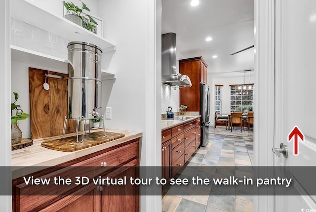 kitchen with range hood and stainless steel refrigerator