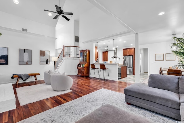 living room featuring high vaulted ceiling, dark wood-type flooring, and ceiling fan