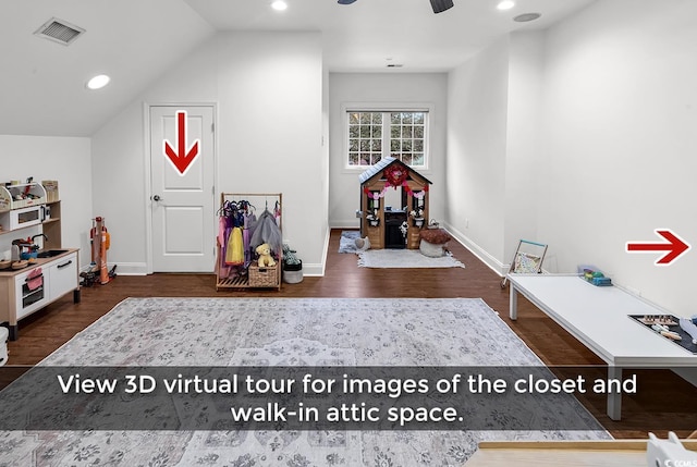 rec room featuring dark wood-type flooring, ceiling fan, and vaulted ceiling