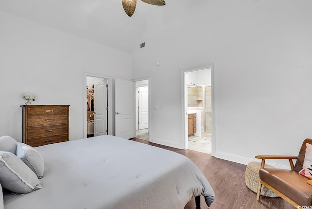 bedroom featuring wood-type flooring, a spacious closet, and ensuite bathroom