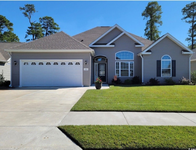 view of front of home with a garage and a front yard