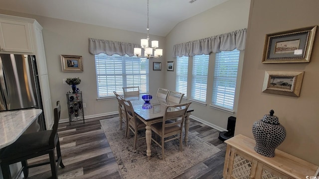 dining area with vaulted ceiling, dark hardwood / wood-style floors, and an inviting chandelier