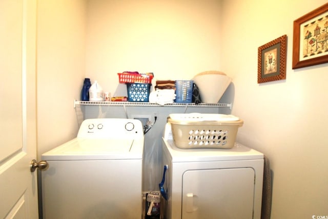 washroom featuring laundry area and separate washer and dryer