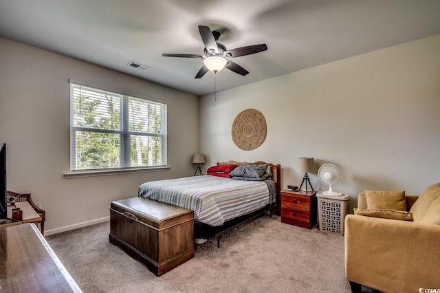 bedroom featuring baseboards, a ceiling fan, visible vents, and light colored carpet