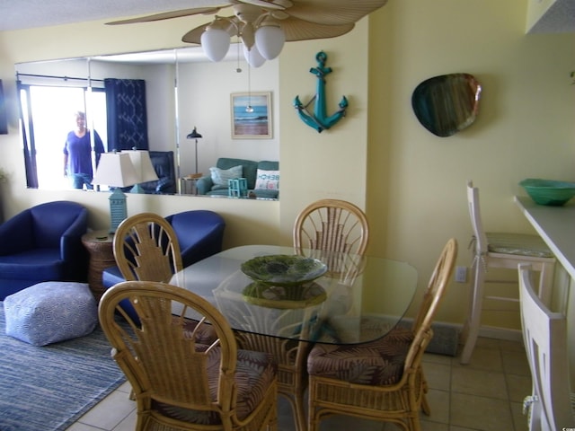 tiled dining room featuring a ceiling fan