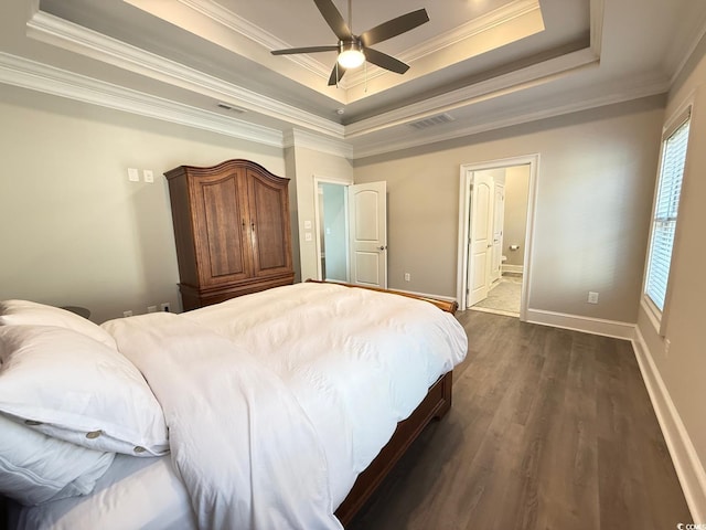 bedroom featuring crown molding, visible vents, a raised ceiling, and dark wood-style flooring