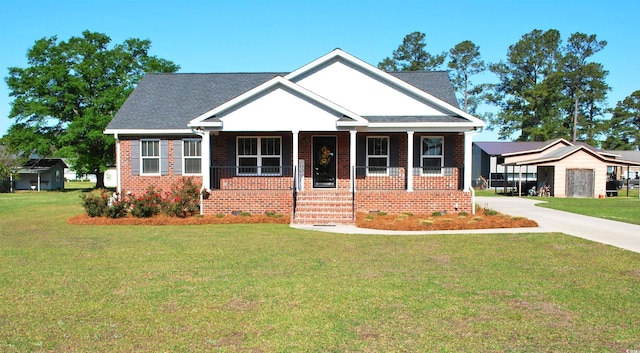 view of front of house with covered porch, a front lawn, concrete driveway, and brick siding