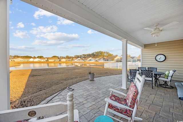 view of patio / terrace with a water view and ceiling fan