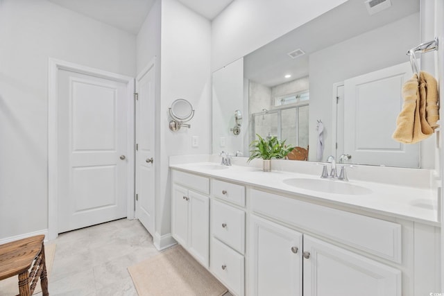 bathroom with vanity and a shower with shower door