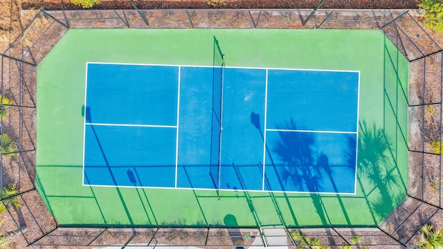 view of tennis court with basketball hoop