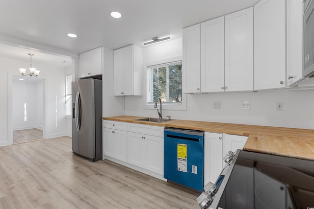 kitchen with stainless steel fridge with ice dispenser, dishwashing machine, wood counters, white cabinetry, and pendant lighting