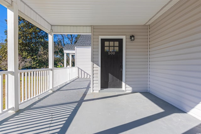 doorway to property with roof with shingles