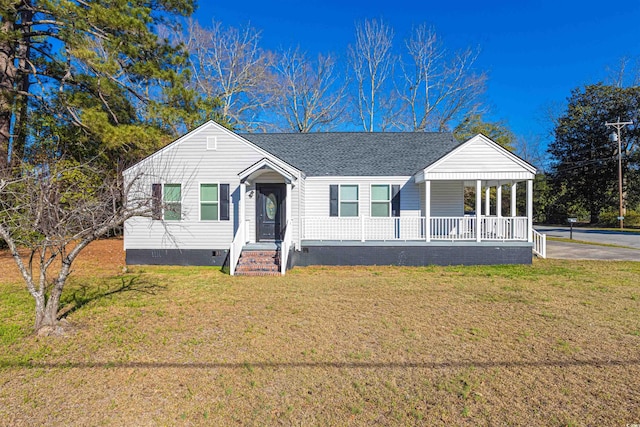 view of front of property with covered porch, a shingled roof, crawl space, and a front yard