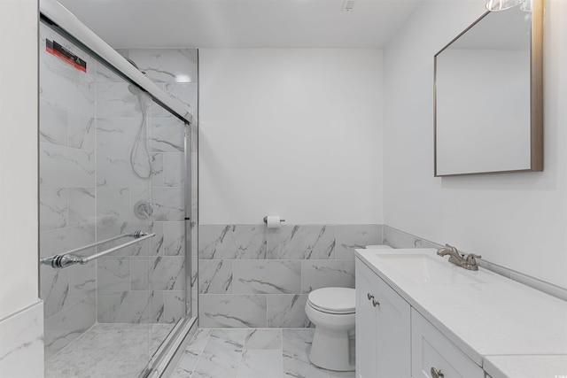 bathroom with toilet, marble finish floor, a marble finish shower, and vanity