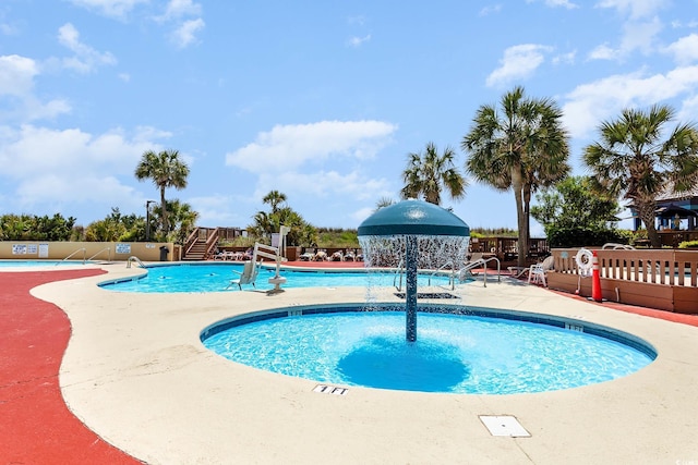 community pool featuring a patio area and fence