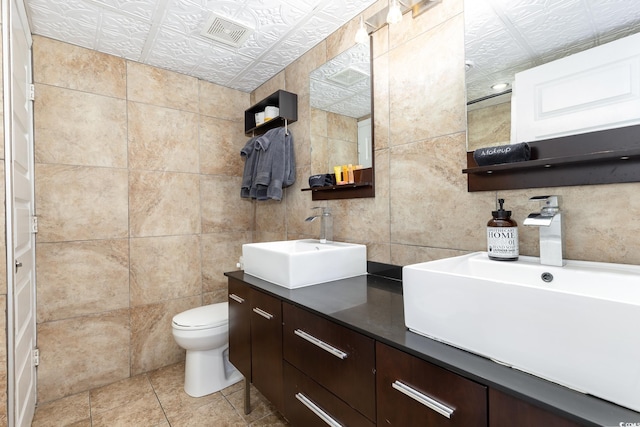 4800 S Ocean Blvd Unit 1514, North Myrtle Beach, SC 29582 - full bathroom with tile walls, toilet, double vanity, tile patterned floors, and an ornate ceiling