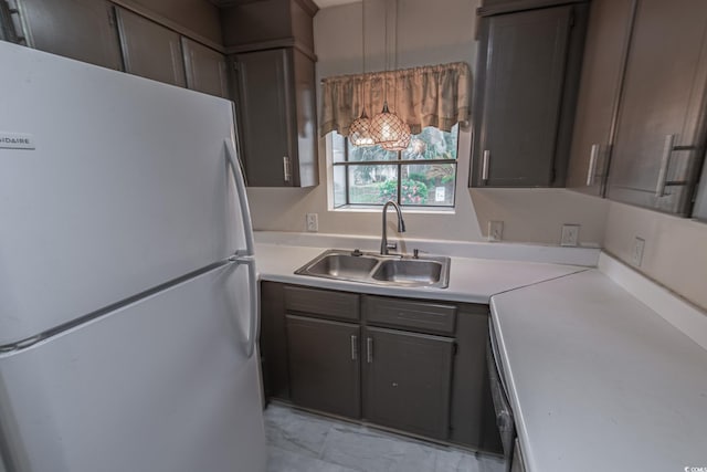 kitchen featuring white fridge and sink