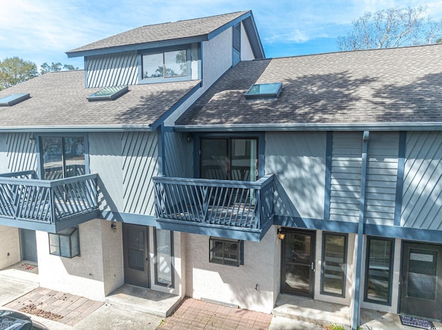 rear view of property with a balcony