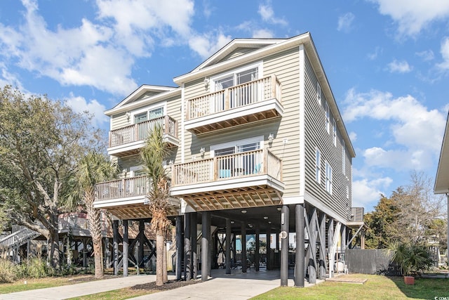 view of front of property featuring a carport and a balcony