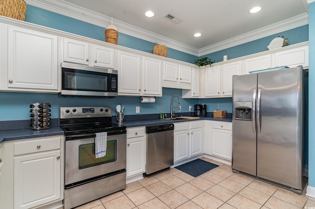 kitchen featuring white cabinetry, sink, ornamental molding, and stainless steel appliances