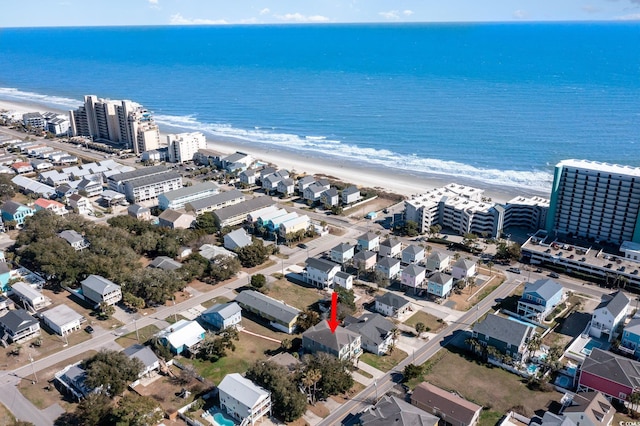 drone / aerial view with a water view and a beach view