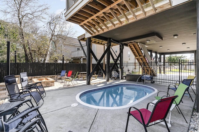 view of pool featuring an outdoor fire pit and a patio