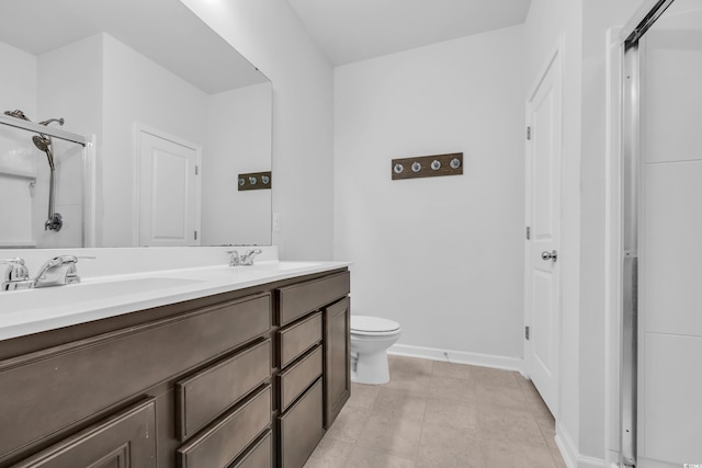 bathroom featuring an enclosed shower, vanity, tile patterned flooring, and toilet