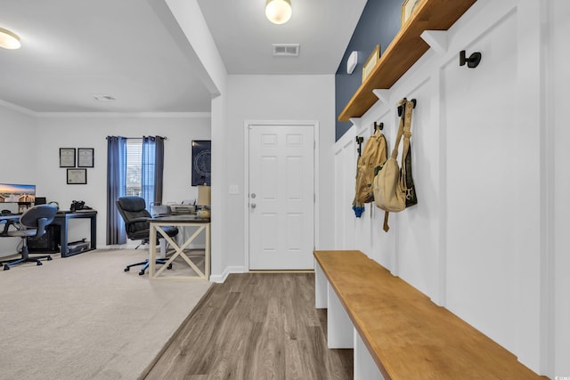 mudroom with crown molding and light hardwood / wood-style flooring