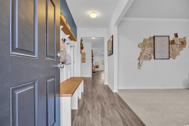 entryway featuring hardwood / wood-style flooring and ornamental molding