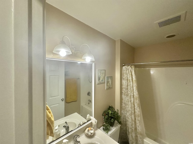 bathroom with shower / tub combo with curtain and sink