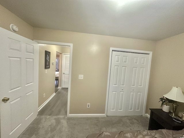 unfurnished bedroom featuring carpet floors and a closet