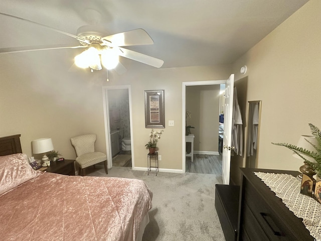 carpeted bedroom featuring connected bathroom and ceiling fan