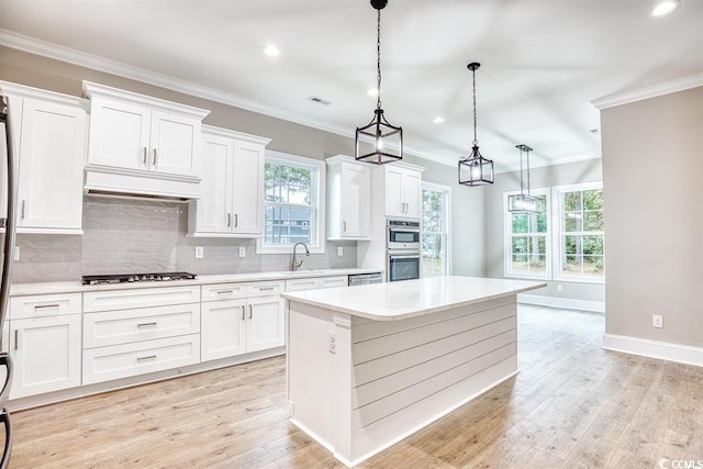 641 Waterbridge Blvd, Myrtle Beach, SC 29579 - kitchen with custom range hood, stainless steel appliances, light countertops, backsplash, and ornamental molding