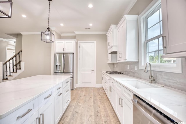 641 Waterbridge Blvd, Myrtle Beach, SC 29579 - kitchen featuring a sink, appliances with stainless steel finishes, crown molding, light wood-style flooring, and white cabinets