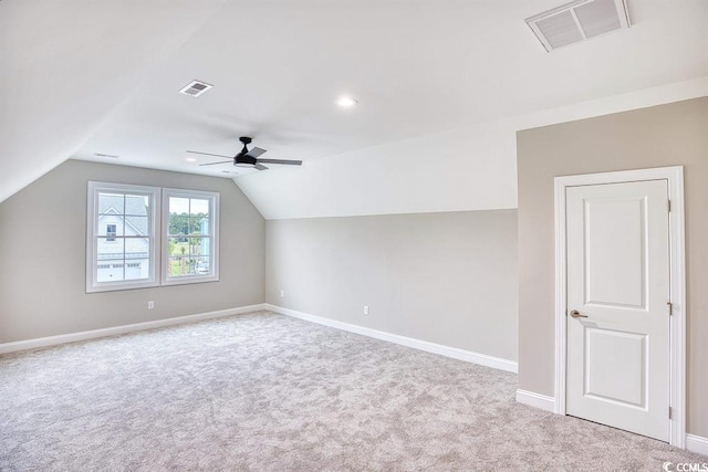 additional living space featuring visible vents, a ceiling fan, carpet floors, and vaulted ceiling