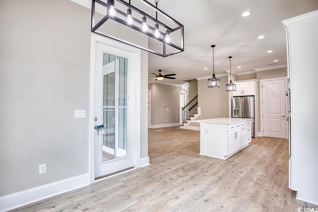 kitchen featuring crown molding, ceiling fan, recessed lighting, white cabinetry, and stainless steel refrigerator with ice dispenser
