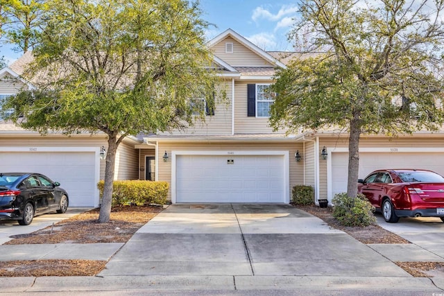 townhome / multi-family property featuring a garage