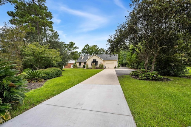 view of front of property with a garage and a front lawn