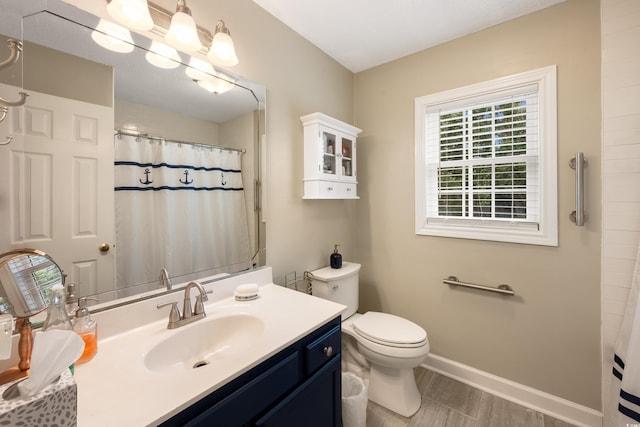 bathroom featuring vanity, a shower with curtain, and toilet