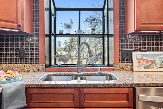 kitchen with sink, light stone counters, and a wealth of natural light