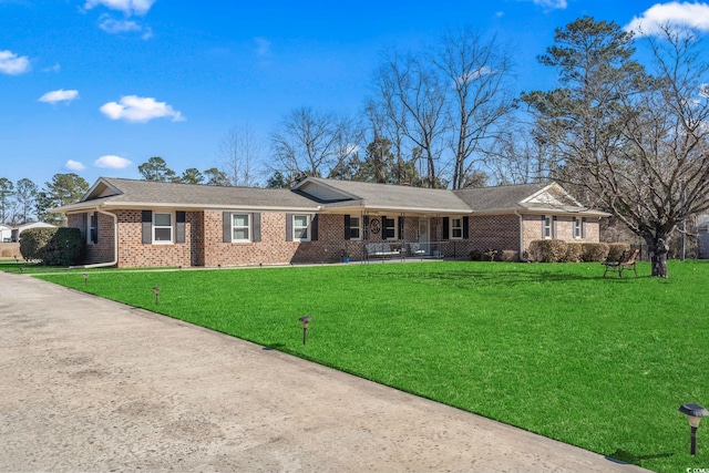 ranch-style home with a front yard and a porch