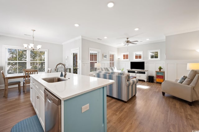 kitchen featuring an island with sink, white cabinetry, sink, hanging light fixtures, and stainless steel dishwasher