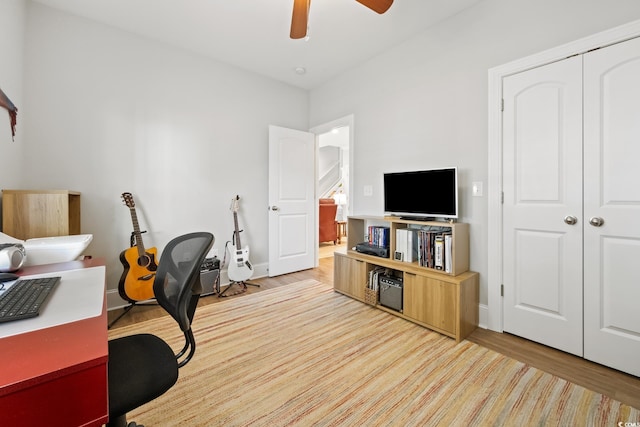 office with hardwood / wood-style flooring and ceiling fan